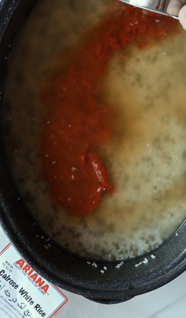 adding tomato sauce to the Calrose rice and mung beans